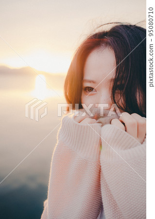 Photo of a woman with a beautiful sunrise 95080710