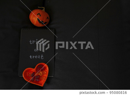 Pumpkin for Halloween notepad with inscription and orange coffee pot place for text black background trick or treat 95080816