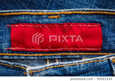 Blue denim jeans with red clothing label 95081934