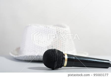 A glittery silver sequin party hat and microphone. Bright paillette hat and presenter microphone. show host accessories. 95083177