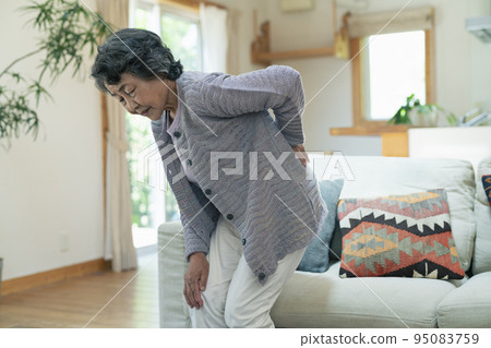 Senior woman suffering from back pain Senior woman suffering from back pain 95083759