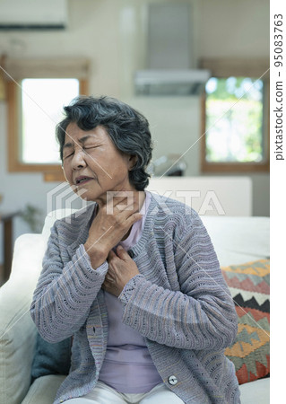 Senior woman who seems to be short of breath Senior woman who seems to be short of breath 95083763