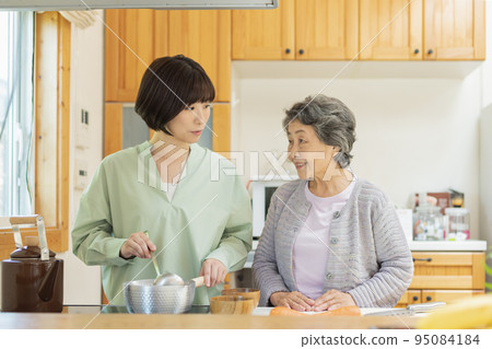 grandson cooking for grandmother grandson cooking for grandmother 95084184