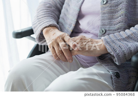 Senior woman on a wheelchair Senior woman on a wheelchair 95084368