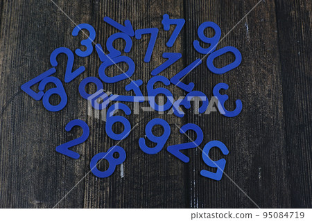 Task in mathematics. Mathematics problem for children. Simple algebra examples using numbers and signs from plastic numbers on a wooden background. 95084719