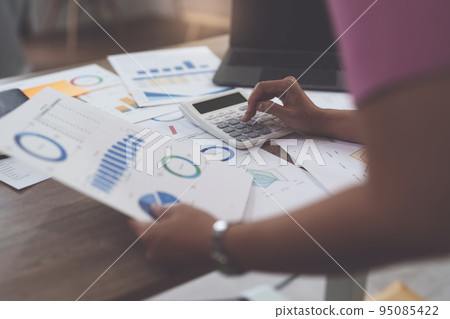 Business woman hand using calculator to calculate the company's financial results and budget. Account Audit Concept 95085422
