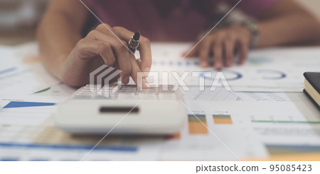 Business woman hand using calculator to calculate the company's financial results and budget. Account Audit Concept 95085423