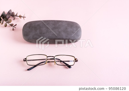 Broken glasses lie next to the hard case. The concept of careful storage of optics Broken glasses lie next to the hard case. The concept of careful storage of optics 95086120