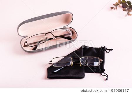 Storage concept - broken glasses on a soft case and whole glasses in a hard case side by side 95086127