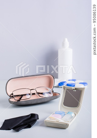 Choice between glasses and contact lenses. Items for care and storage. Vertical view 95086139