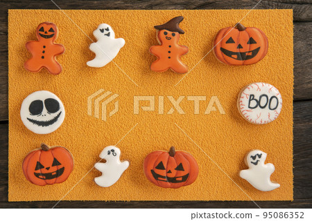 Gingerbread frame with Halloween theme on orange background. Space for text, advertising layout Gingerbread frame with Halloween theme on orange background. Space for text, advertising layout 95086352