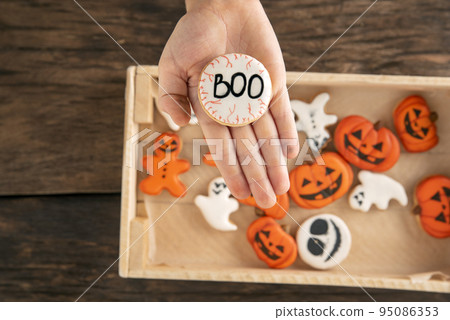 Halloween gingerbread. Cookies in the form of ghost and pumpkins. Cookies with Boo on the palm. Halloween gingerbread. Cookies in the form of ghost and pumpkins. Cookies with Boo on the palm. 95086353