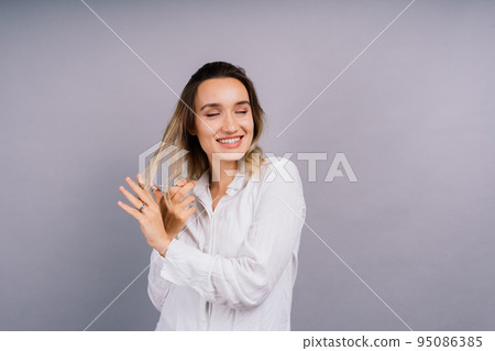 Woman with scissors having hair cut. Amazed female with straight hair, scissor. Haircare concept. 95086385