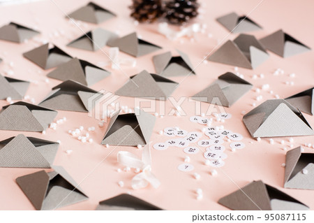 Envelopes and numbers for making an advent calendar on a table in Christmas decorations 95087115
