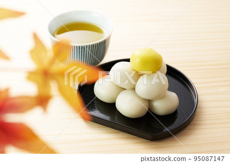 Tsukimi dango with a wooden background Tsukimi dango with a wooden background 95087147