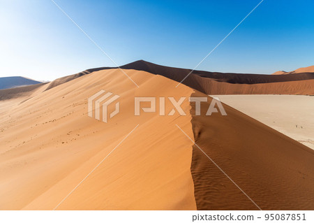 Sun rising over the red sand dunes of the Namib Desert, Namibia. Stock  Photo