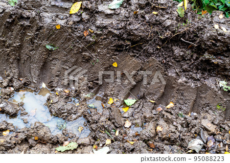 Tire tracks in autumn mud and slush. Close-up. Tire tracks in autumn mud and slush. Close-up. 95088223
