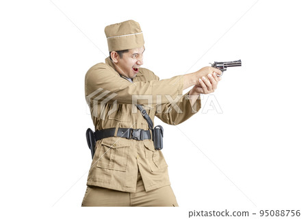 Indonesian freedom fighter standing while holding gun 95088756