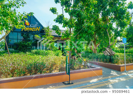 Lampang, Thailand - December 2, 2020: Coffee Shop Amazon is a popular coffee shop that people buy and drink because of its delicious aroma and taste. Outside the shop has a beautiful garden setting. 95089461