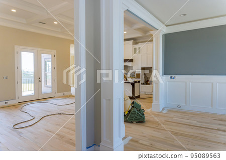 Grinding a wooden parquet floor by using floor sander in newly constructed house to ensure that it is smooth even 95089563