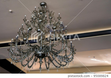 Magnificent baroque chandelier hangs on the ceiling Magnificent baroque chandelier hangs on the ceiling 95089824
