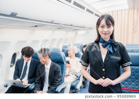 Passengers spending time on board an airplane Passengers spending time on board an airplane 95089969