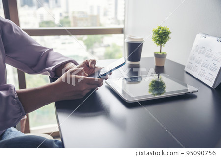 Close up Woman Hands Using Smartphone Shopping online at office desk. Woman touch screen holding smartphone open website social. Online Shopping Website on Laptop. Easy Website Shop by cellphone Close up Woman Hands Using Smartphone Shopping online at office desk. Woman touch screen holding smartphone open website social. Online Shopping Website on Laptop. Easy Website Shop by cellphone 95090756