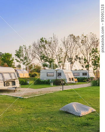 Pillow or mattress for relax on green grass with Cozy retro travel trailer Caravan near riverside in peaceful countryside.Family vacation travel RV, holiday trip in motorhome.Outdoor and Recreational Pillow or mattress for relax on green grass with Cozy retro travel trailer Caravan near riverside in peaceful countryside.Family vacation travel RV, holiday trip in motorhome.Outdoor and Recreational 95091328