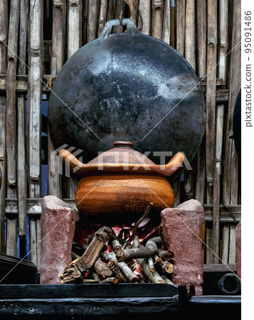 Variety and types of utensils for simple cooking of Asian families in the past. Traditional Asia and Thai old kitchen style interior. Antique kitchen with utensils at bamboo cottage. Selective focus. Variety and types of utensils for simple cooking of Asian families in the past. Traditional Asia and Thai old kitchen style interior. Antique kitchen with utensils at bamboo cottage. Selective focus. 95091486