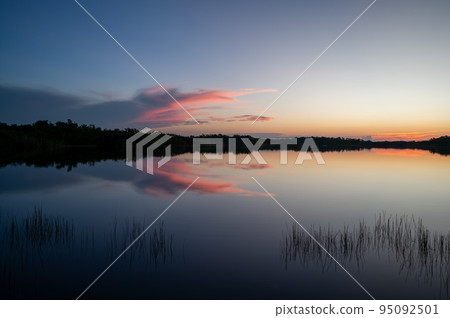 Colorful sunrise over pond in Everglades National Park. 95092501