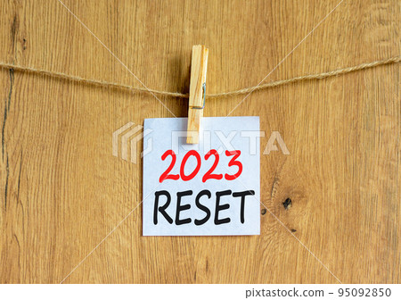 2023 Reset symbol. White paper with words 2023 Reset, clip on wooden clothespin. Beautiful wooden background. Business and 2023 reset concept. Copy space. 2023 Reset symbol. White paper with words 2023 Reset, clip on wooden clothespin. Beautiful wooden background. Business and 2023 reset concept. Copy space. 95092850
