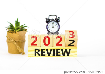 2023 review new year symbol. Turned a wooden cube and changes words Review 2022 to Review 2023. Black alarm clock. Beautiful white background, copy space. Business 2023 review new year concept. 2023 review new year symbol. Turned a wooden cube and changes words Review 2022 to Review 2023. Black alarm clock. Beautiful white background, copy space. Business 2023 review new year concept. 95092959
