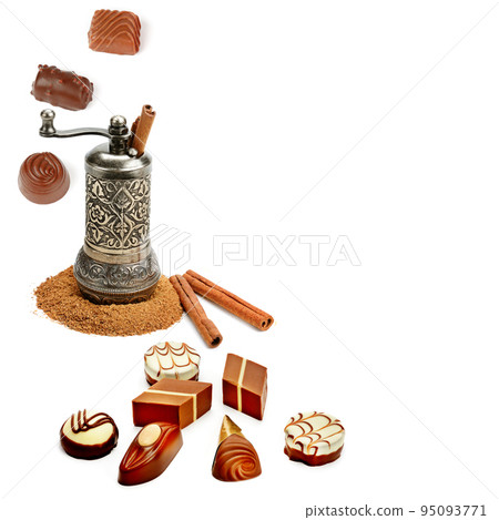 Cinnamon sticks and powder, hand mill, chocolate candies isolated on white . Cinnamon sticks and powder, hand mill, chocolate candies isolated on white . 95093771