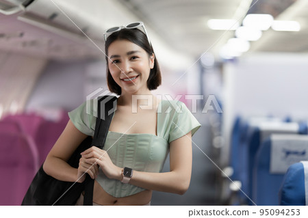 Backpacker asian woman in the airplane while to destination. Travel concept Backpacker asian woman in the airplane while to destination. Travel concept 95094253