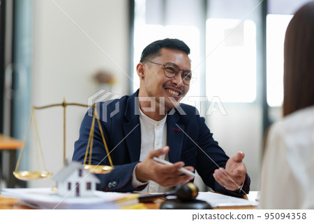 Business woman and lawyers discussing contract papers with brass scale on wooden desk in office. Law, legal services, advice, Justice concept Business woman and lawyers discussing contract papers with brass scale on wooden desk in office. Law, legal services, advice, Justice concept 95094358