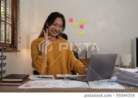 Asian Accountant video call with client by laptop. work from home concept 95094359