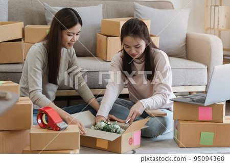 Two Asian SME business woman working at home office. online shopping concept Two Asian SME business woman working at home office. online shopping concept 95094360