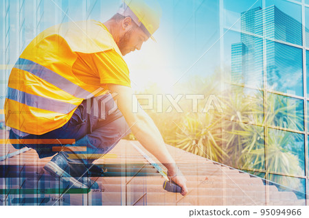 Technical worker takes measurements on the roof of a house 95094966