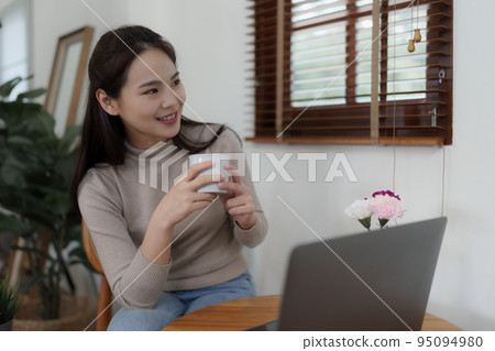 Beautiful woman relaxing and drinking coffee in morning at home Beautiful woman relaxing and drinking coffee in morning at home 95094980