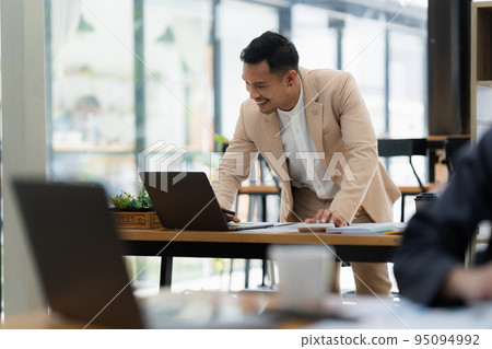 Asian Businessman smiling and working to analyze technical price graph and indicator. finance concept 95094992