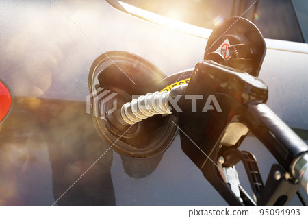 Fuel pump fill a tank of a car in a station Fuel pump fill a tank of a car in a station 95094993