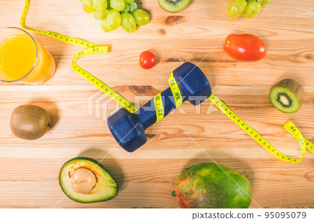 Fitness with dumbbell and genuine food with fresh fruit 95095079