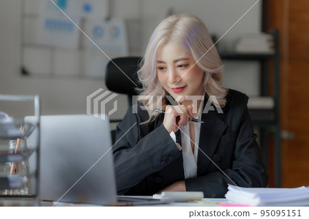 Accountant checking data document on laptop for investigation of corruption account Accountant checking data document on laptop for investigation of corruption account 95095151