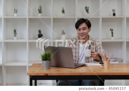 Asian man using laptop computer working at office. Creative and new idea concpet 95095157