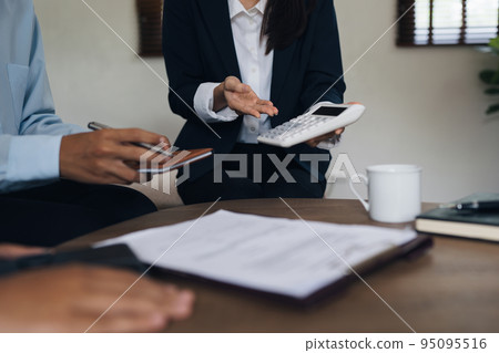 Young couple consultations with a insurance agent. saving and insurance concept Young couple consultations with a insurance agent. saving and insurance concept 95095516