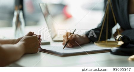 Business woman and lawyers discussing contract papers with brass scale on wooden desk in office. Law, legal services, advice, Justice concept 95095547