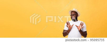 Closeup portrait of shocked mad young man raising hand up to say no stop right there, isolated on yellow background. Negative emotion facial expression feelings, signs symbols, body language. Closeup portrait of shocked mad young man raising hand up to say no stop right there, isolated on yellow background. Negative emotion facial expression feelings, signs symbols, body language. 95095735