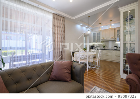 Studio apartment with living room and white large kitchen, dining table Studio apartment with living room and white large kitchen, dining table 95097322