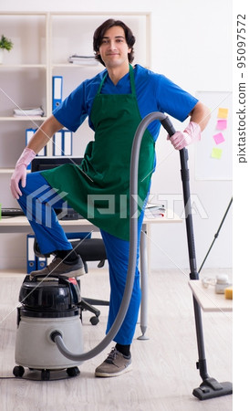 Male handsome professional cleaner working in the office 95097572