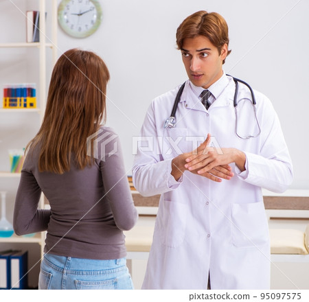 Deaf-mute female patient visiting young male doctor 95097575